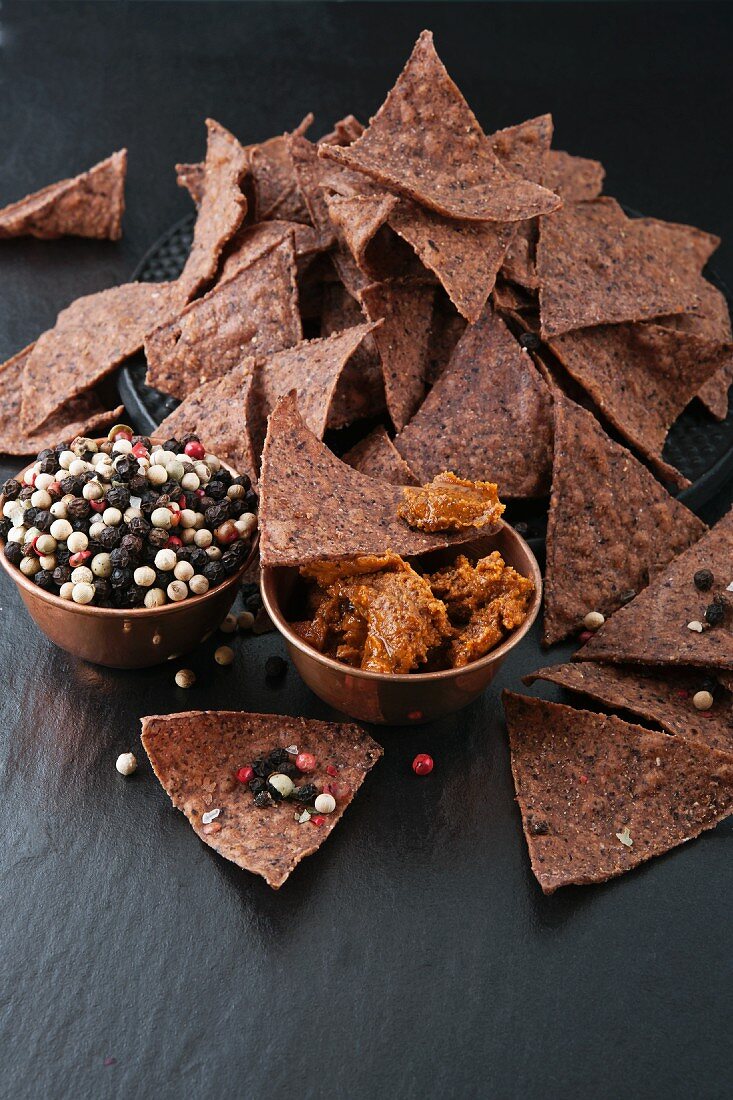 Tortilla chips with dip and peppercorns