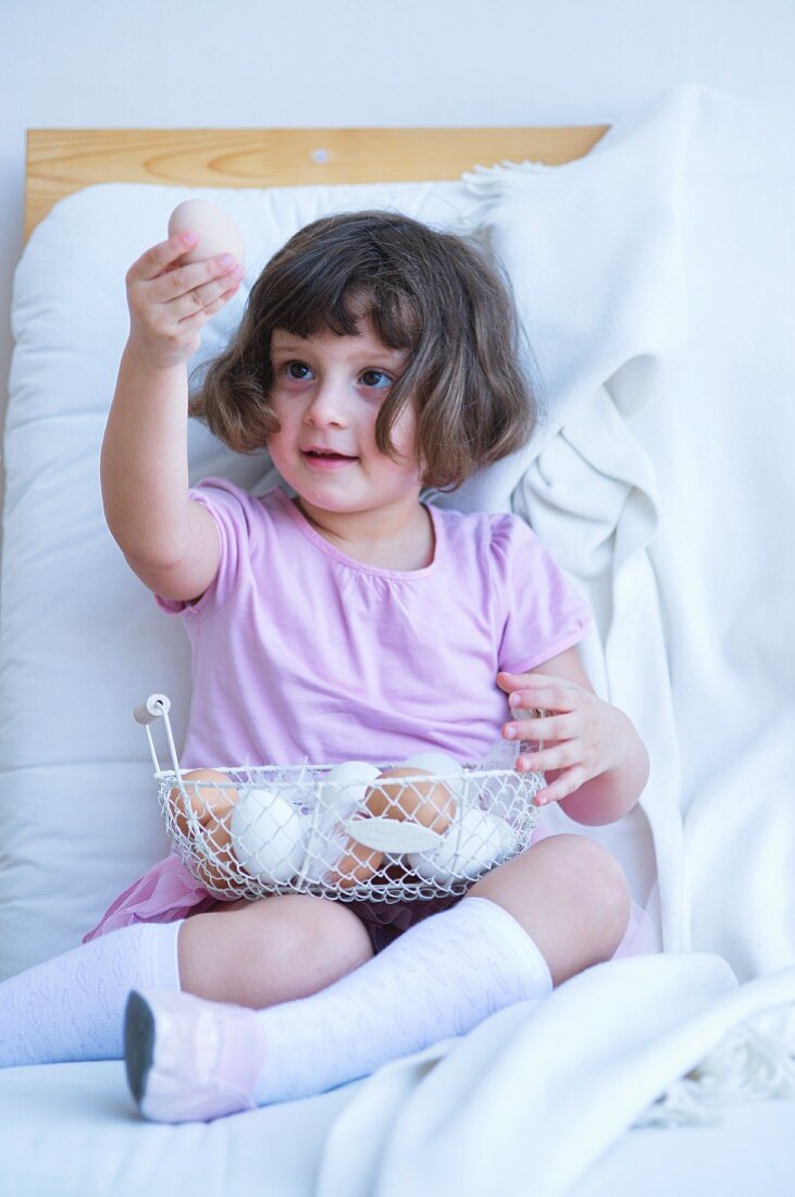 Little girl looking at egg