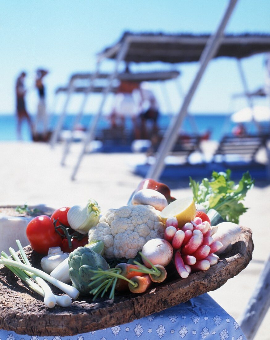 Fresh vegetables in a dish on a beach in St Tropez