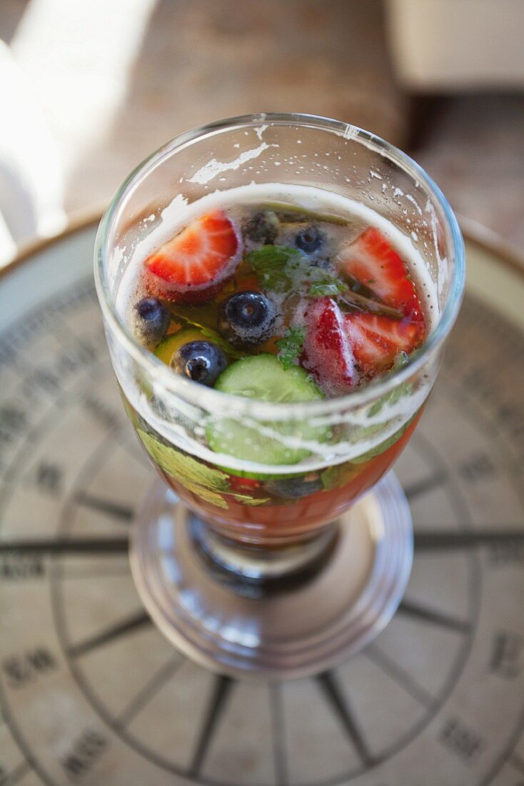 A berry & cucumber drink in a glass