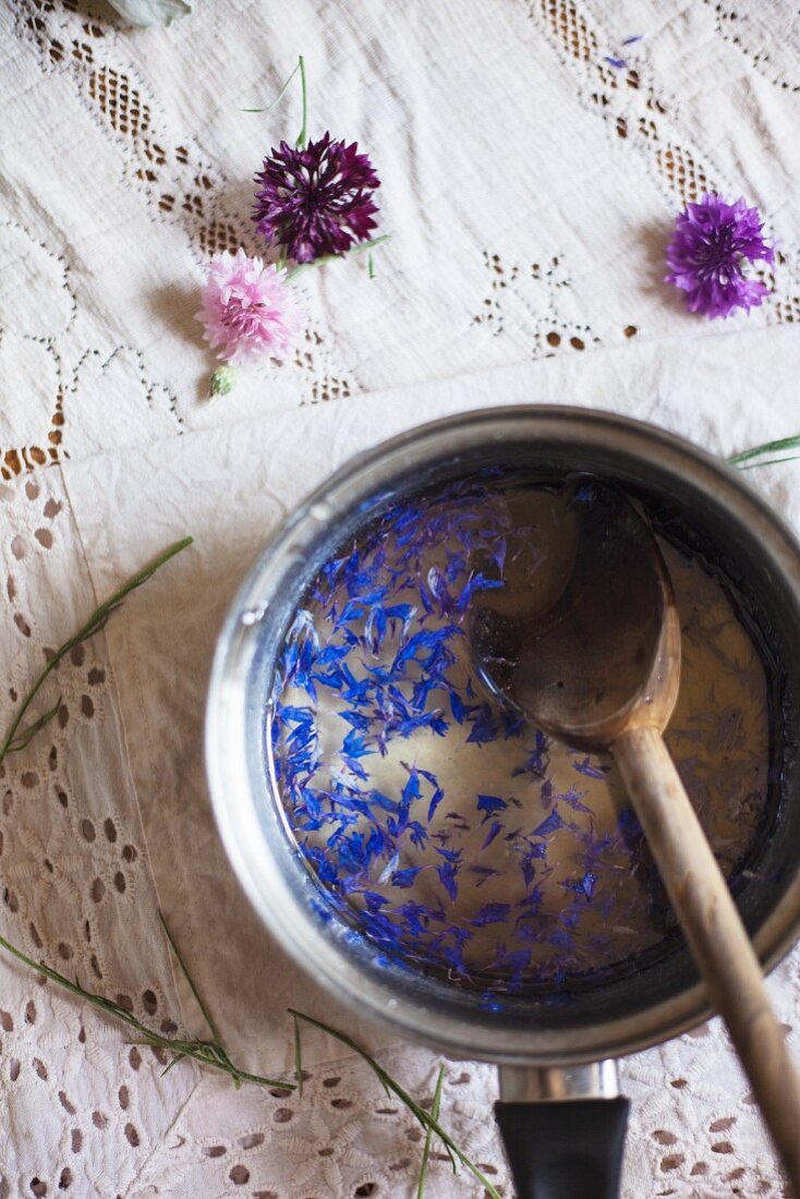 Stirring Ingredients for a Cornflower Gin Cocktail in a pot
