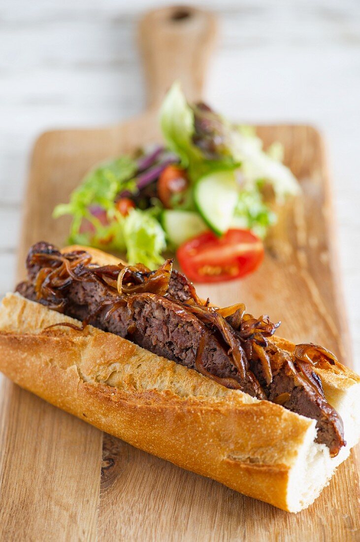 Baguette filled with fried sausage and onions