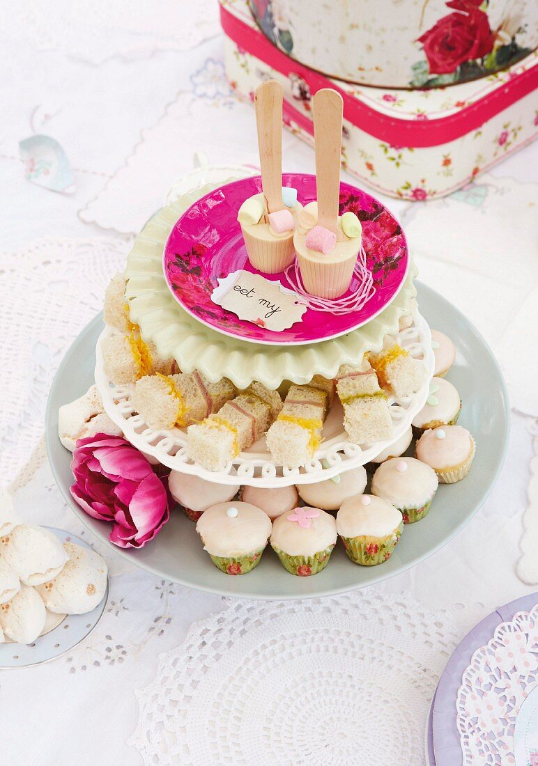A vintage children's birthday party in a garden with mini cupcakes
