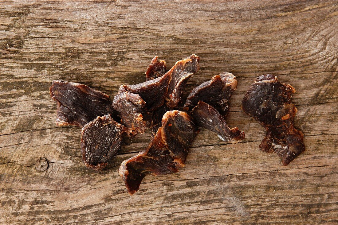 Dried beef on a wooden surface