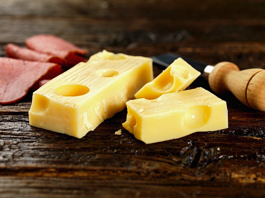 Emmental and ham on a wooden surface