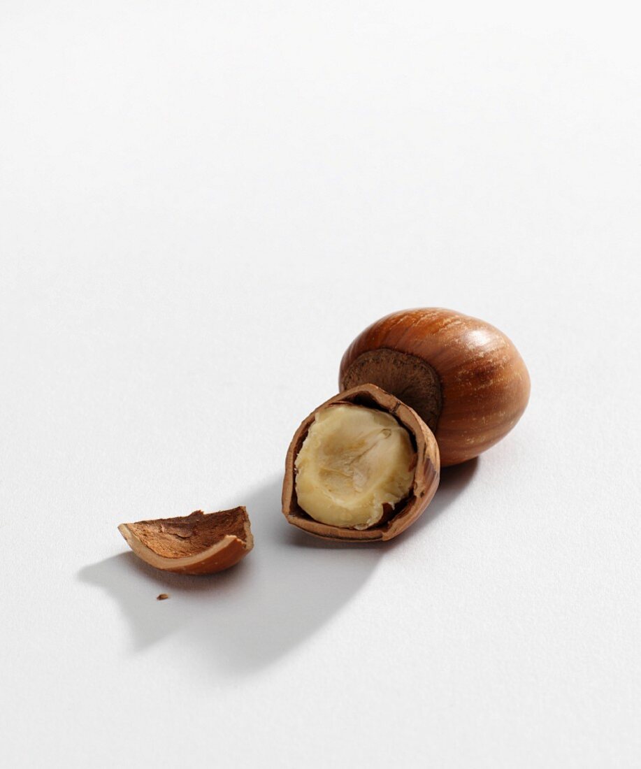 A whole hazelnut and one broken open