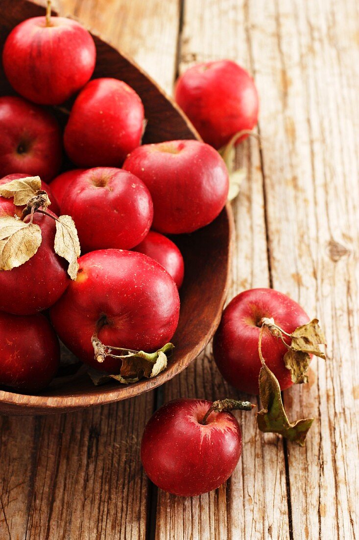 Red apples in a wooden bowl