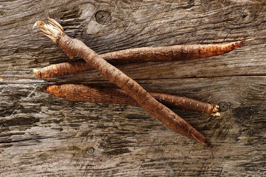 Black salsify on a rustic wooden table