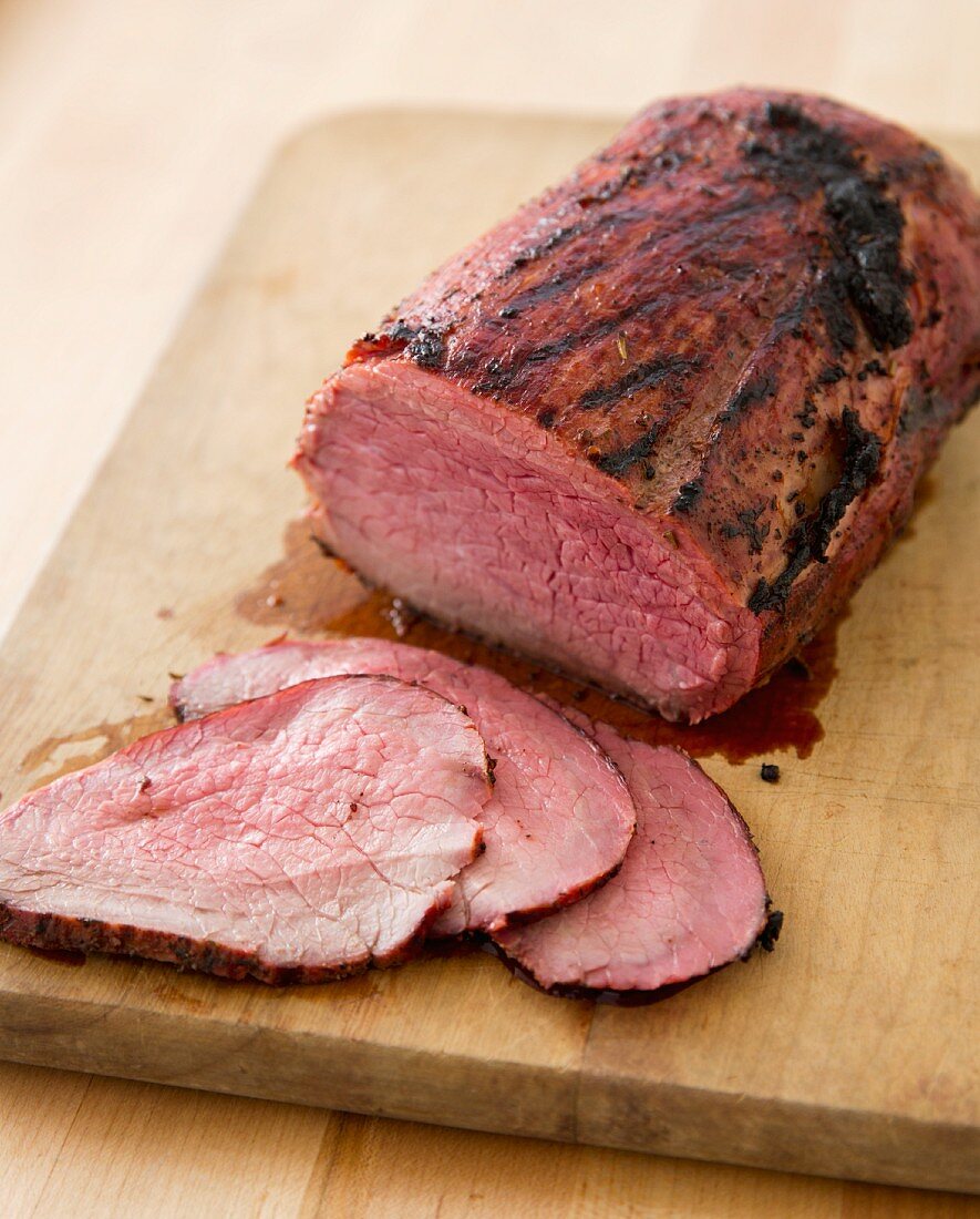 Smoked Roast Beef Sliced on a Wooden Cutting Board