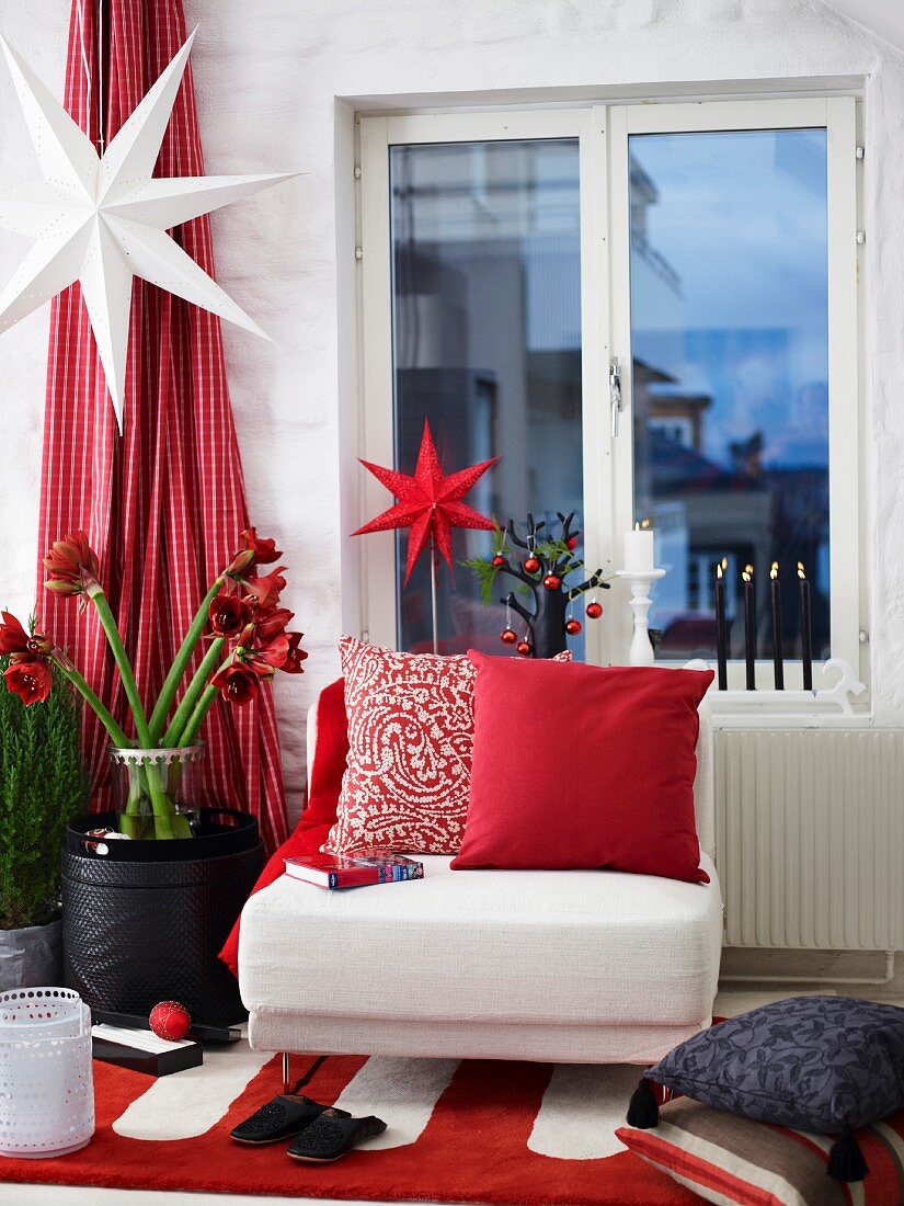 Festively decorated living room with armchair below window