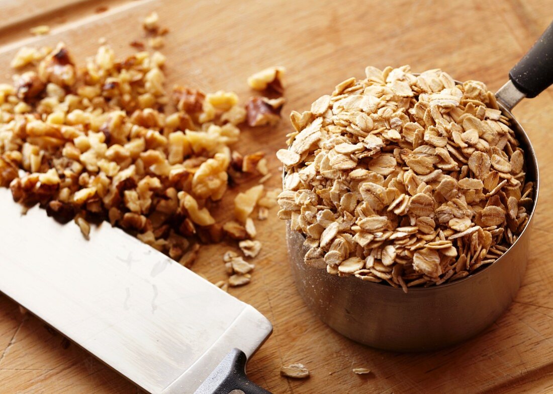 A Measuring Cup of Oats with Chopped Walnuts