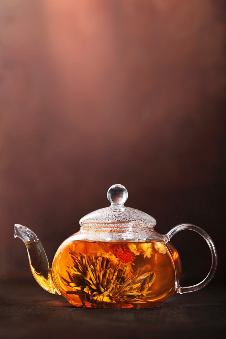 Tea flowers in a glass teapot