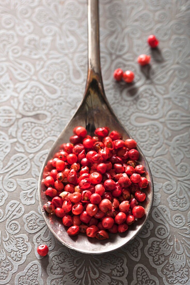 Pink peppercorns on a spoon (view from above)