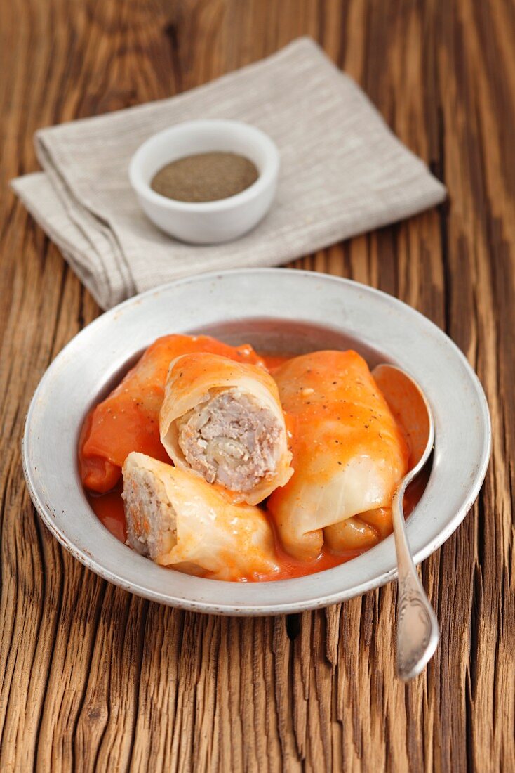 Minced pork and rice wrapped in cabbage leaves, in tomato sauce