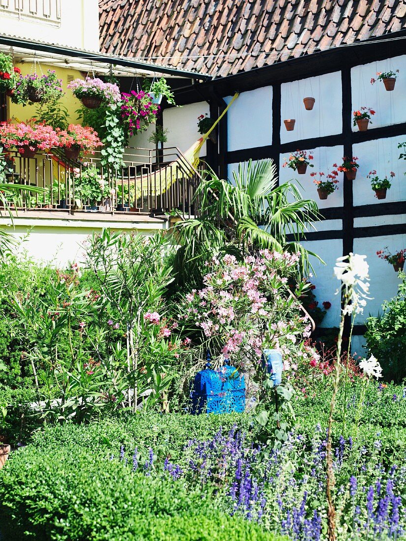 Half-timbered house with veranda & summery garden