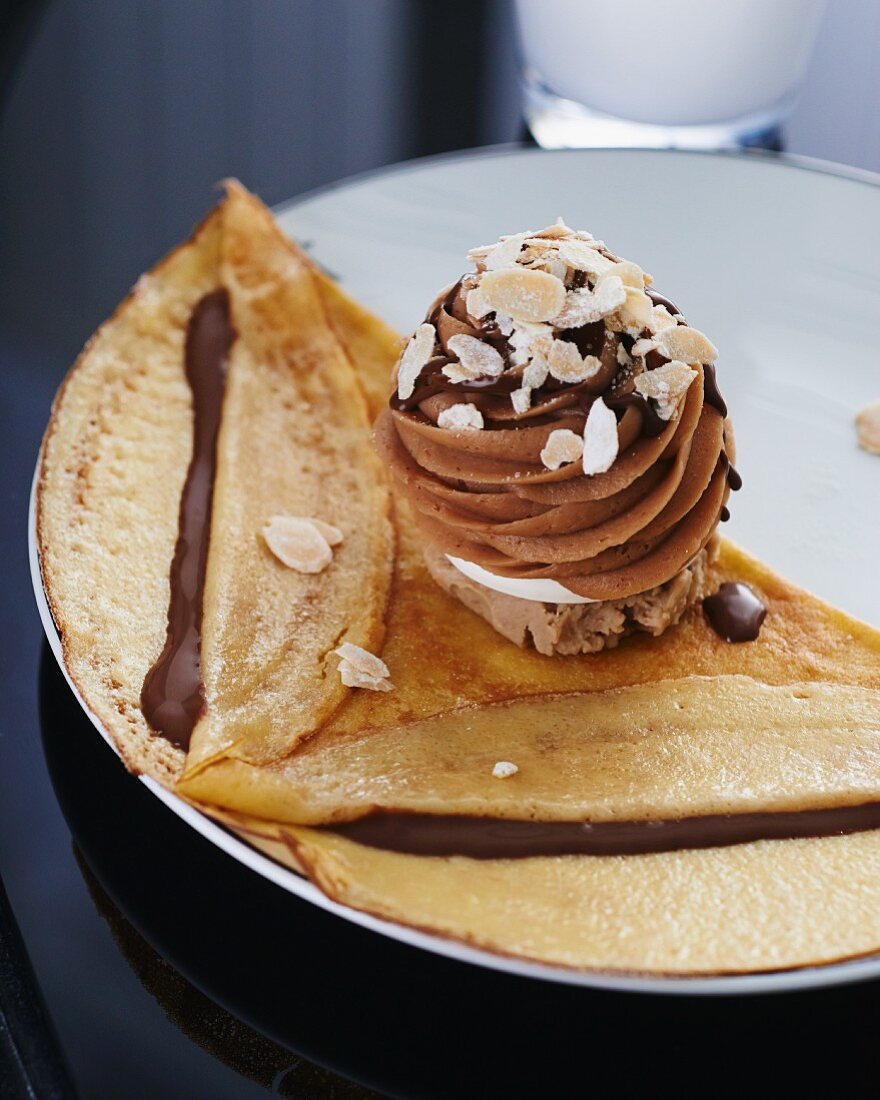 A pancake with chocolate sauce and chestnut mousse