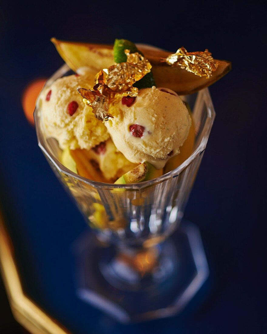 Ice cream sundae with fruit and gold leaf