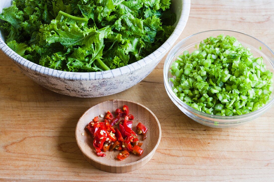 Bowl of chopped mustard greens, chopped stems & chilli