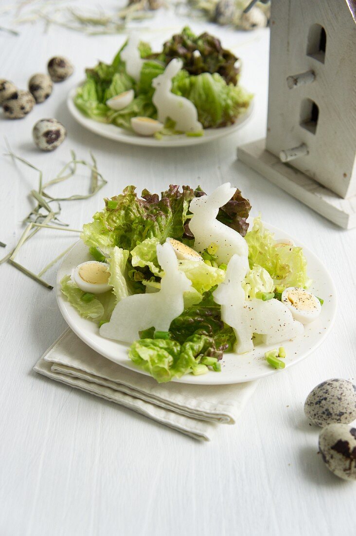 A mixed leaf salad with rabbit-shaped radishes and quails eggs