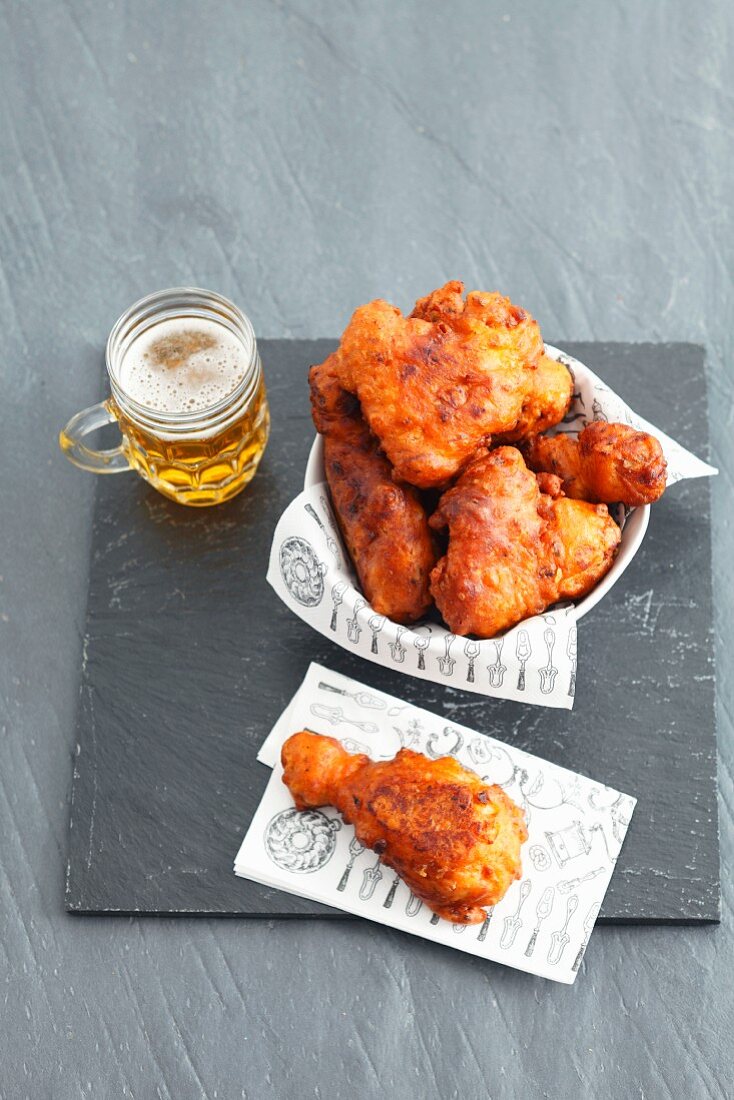 Fried chicken pieces with a glass of beer