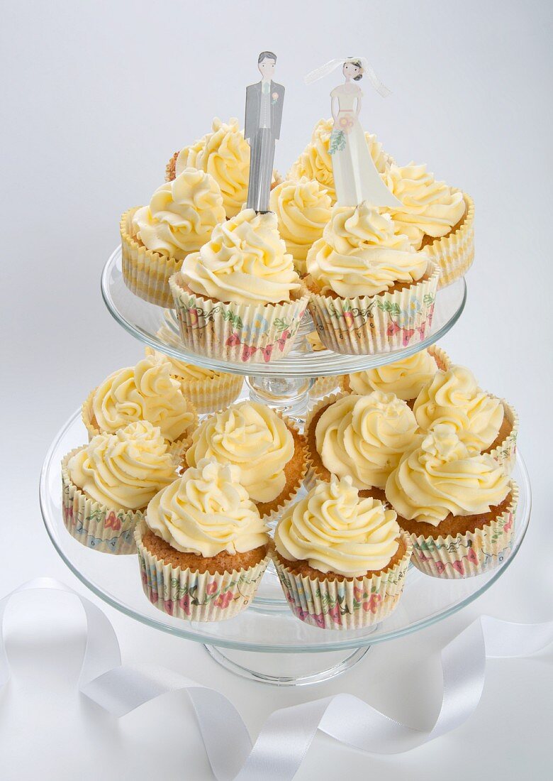 Wedding cupcakes with buttercream on a tiered cake stand