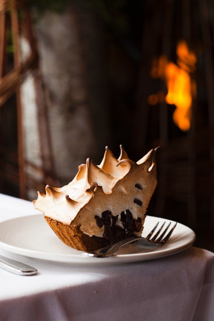 A Slice of S'more Pie on a White Plate; Fireplace