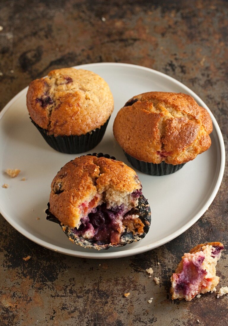 Blueberry and apricot muffins, one partly eaten