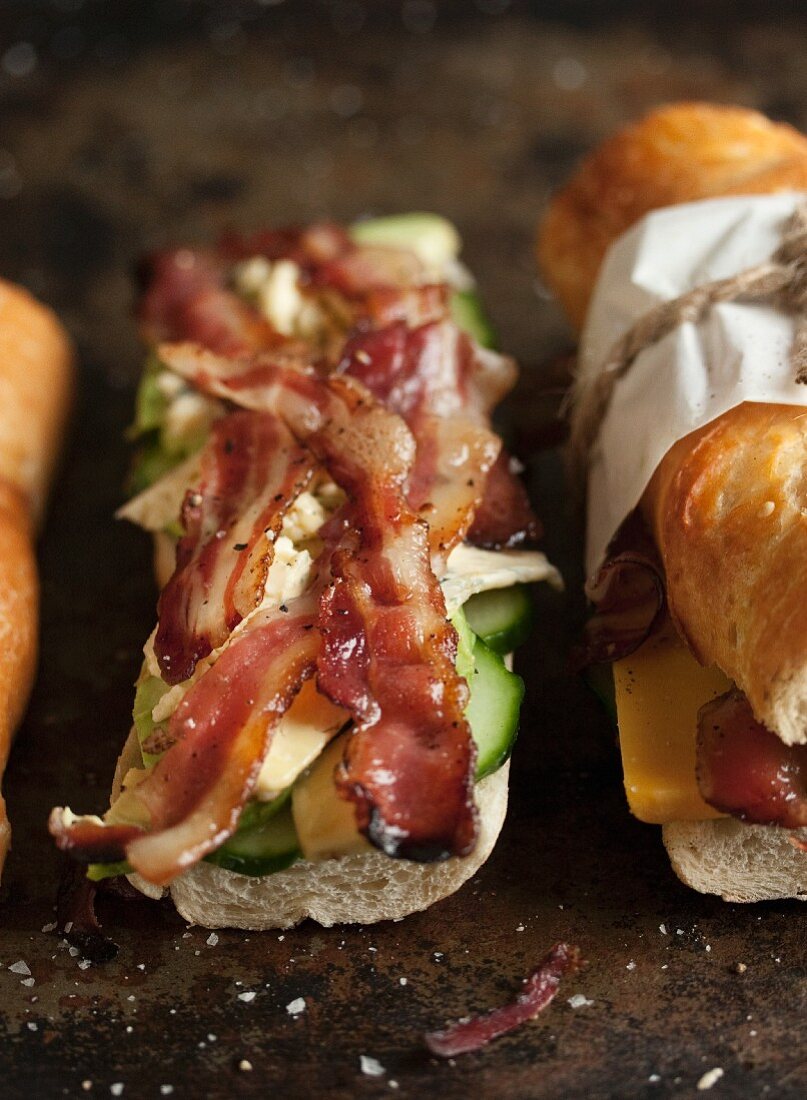 A baguette filled with bacon, blue cheese and cucumber