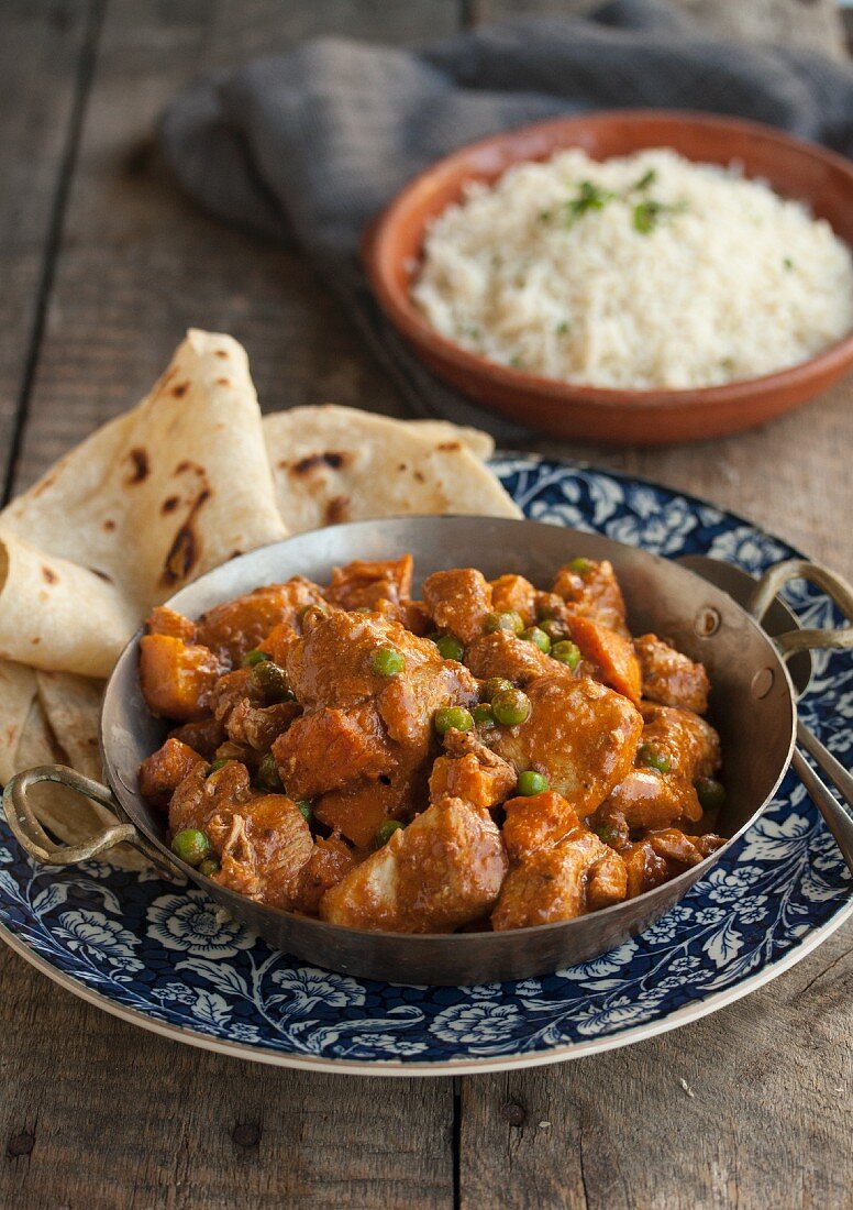 Chicken curry with peas, flatbread and rice