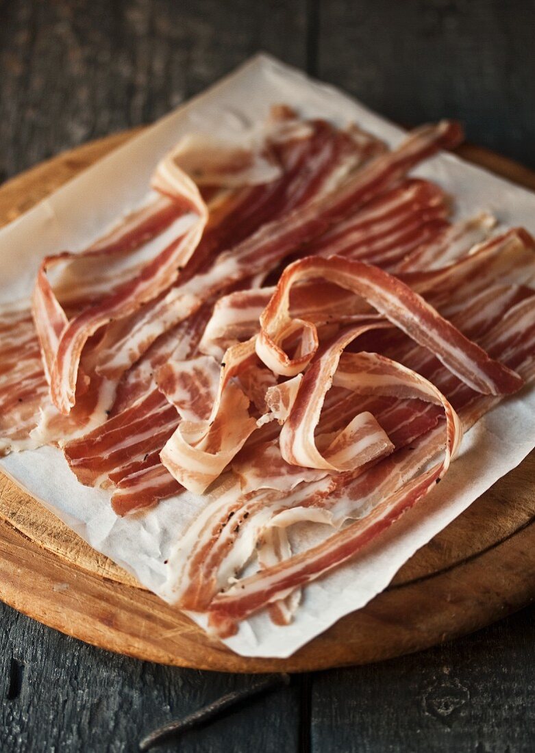 Rashers of smoked bacon on a chopping board
