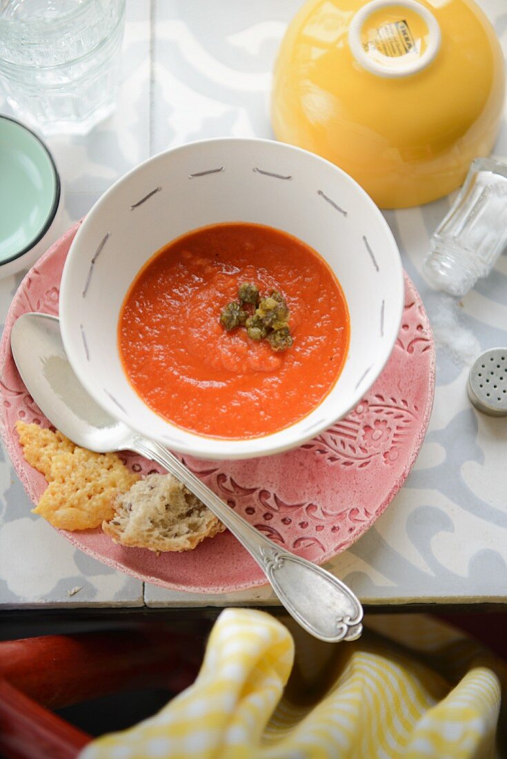 Tomato soup with fried capers and parmesan crisps