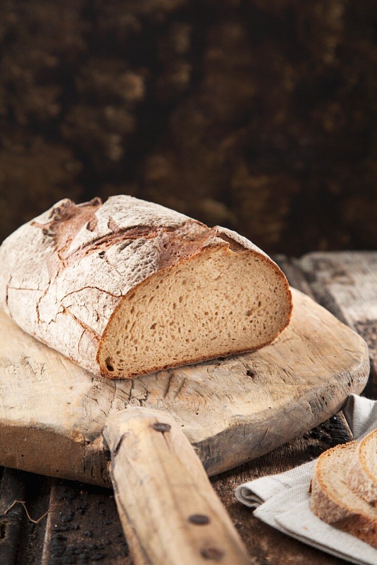 Homemade round Loaf of Bread; Partially Sliced