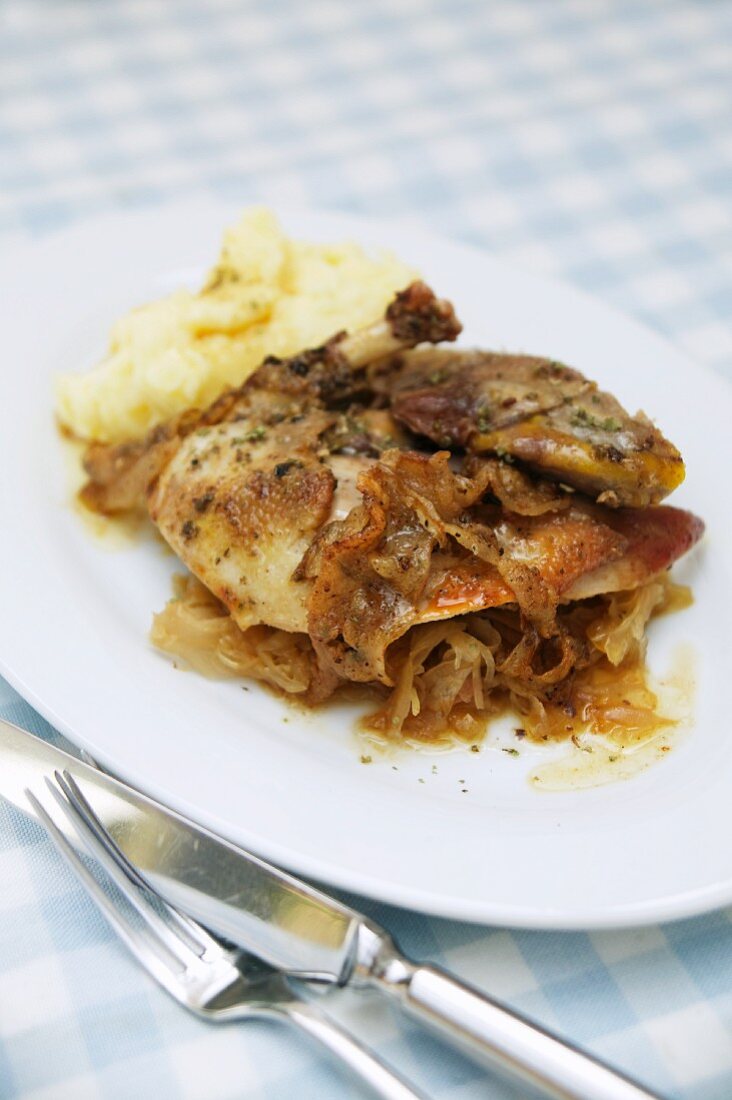 Roast pheasant on a bed of wine sauerkraut with mashed potato
