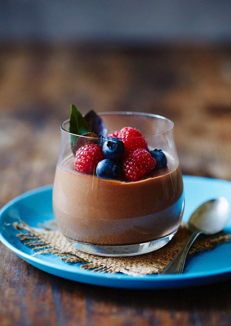 Chocolate mousse in a glass with fresh berries
