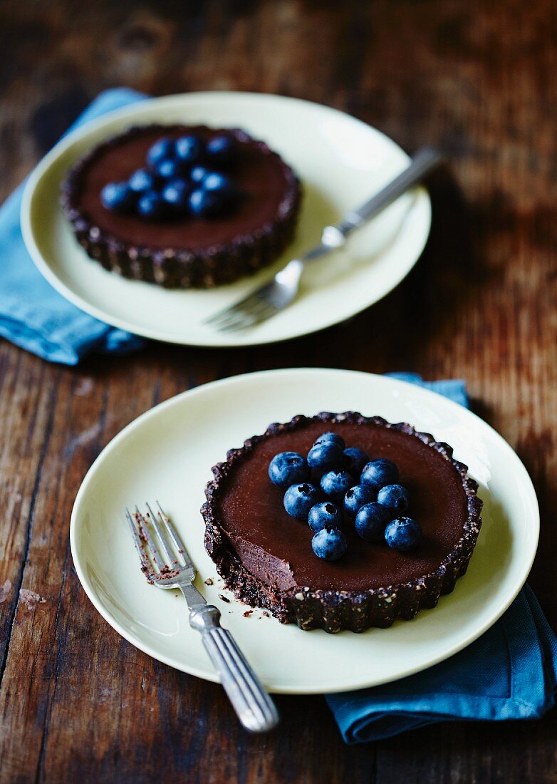 Individual chocolate tarts with fresh blueberries
