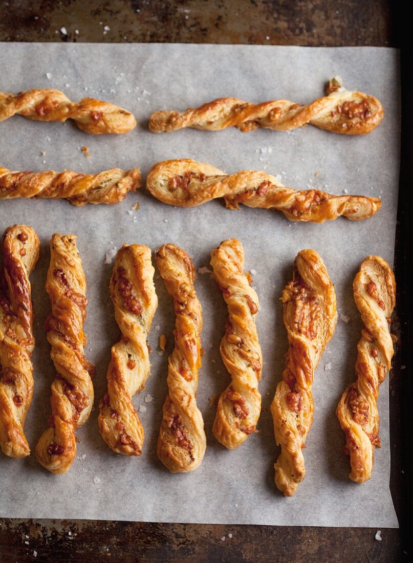 Tangy cheese straws on a baking tray