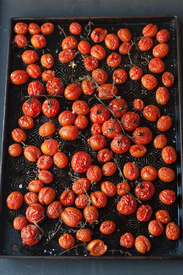 Oven-roasted cherry tomatoes on the baking tray