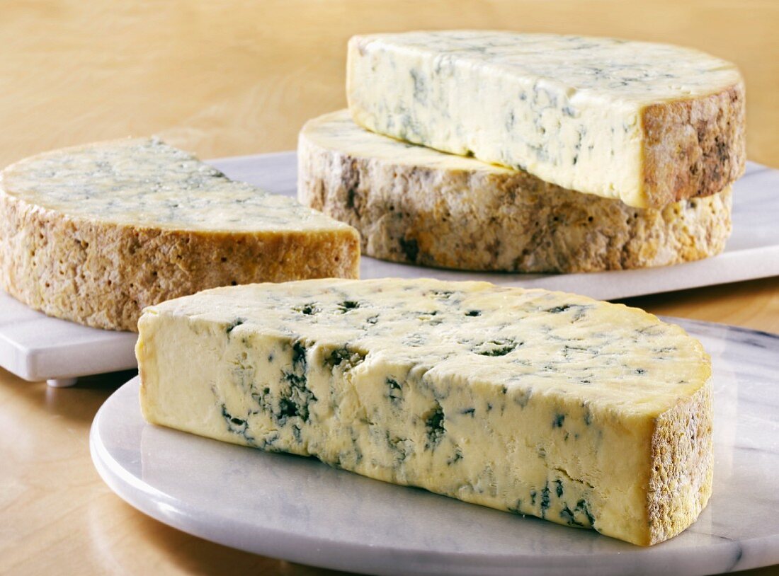 Several half moons of Stilton on marble boards