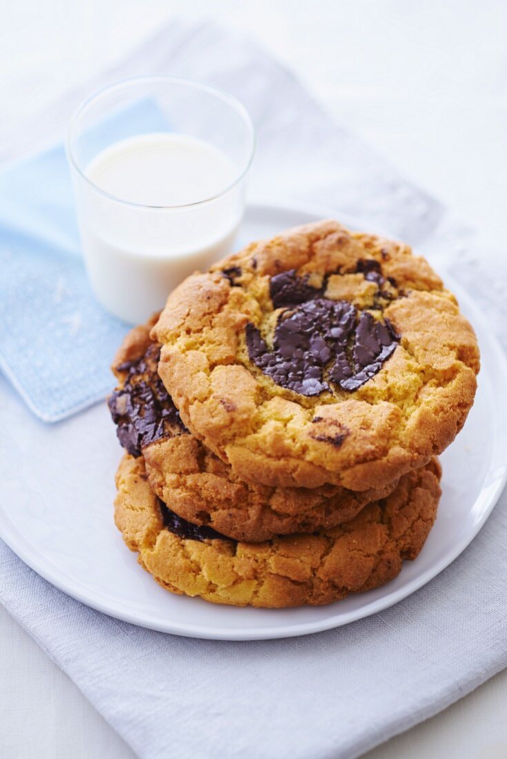 A stack of cookies and a glass of milk