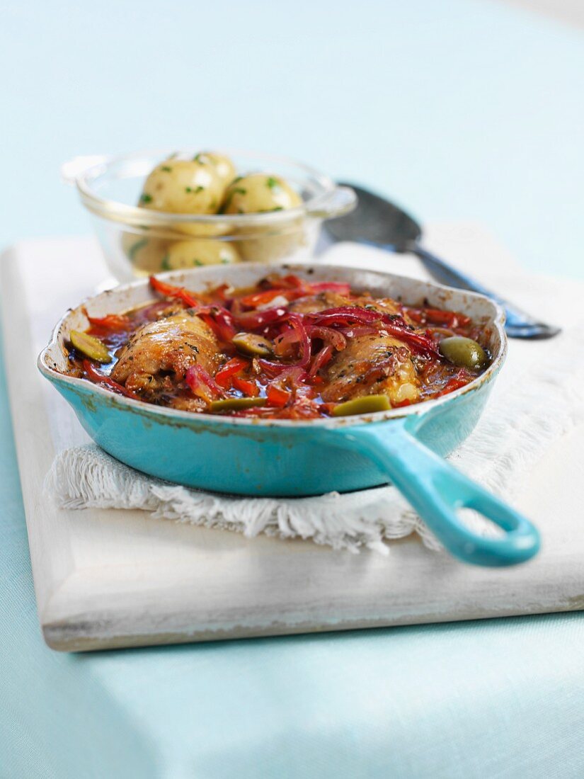 Chicken stew with peppers and olives, with parsley potatoes on the side