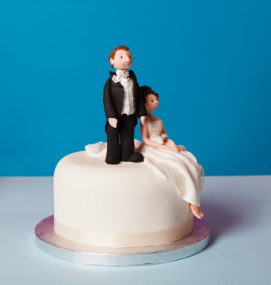 A small wedding cake with a bridal couple