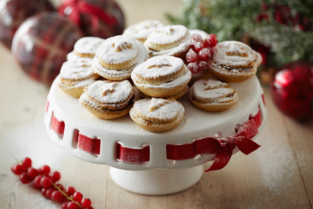 Mince pies with icing sugar on a cake stand for Christmas