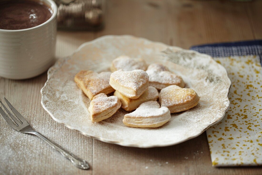 Puff pastry hearts with icing sugar for Christmas