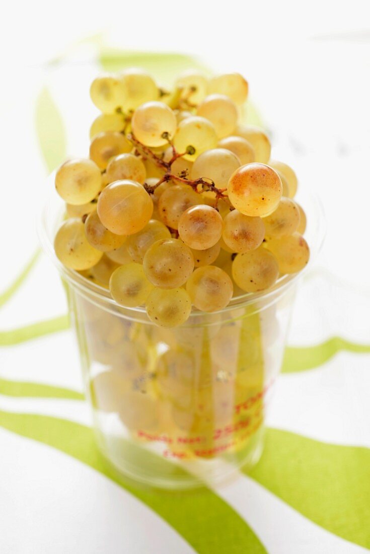 Chasselas grapes in a plastic tumbler