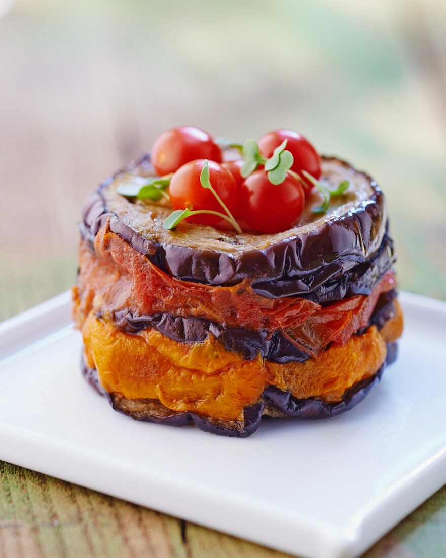A stack of chargrilled aubergine with tomatoes