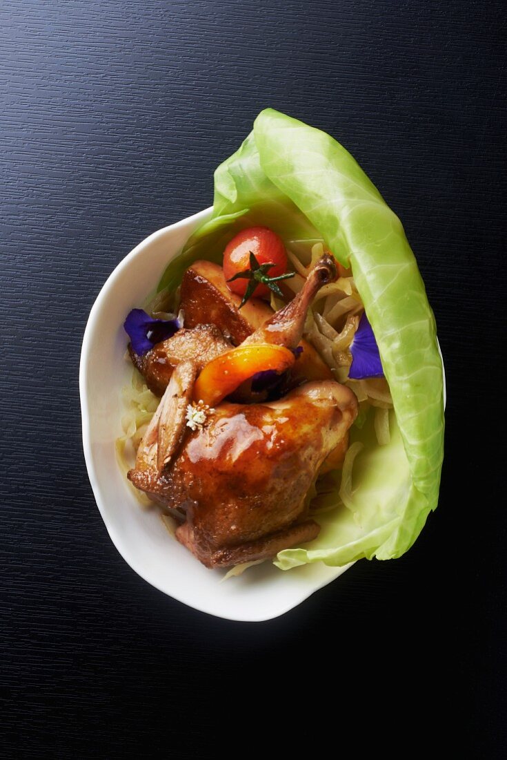 Quail with goose liver in a leaf of white cabbage