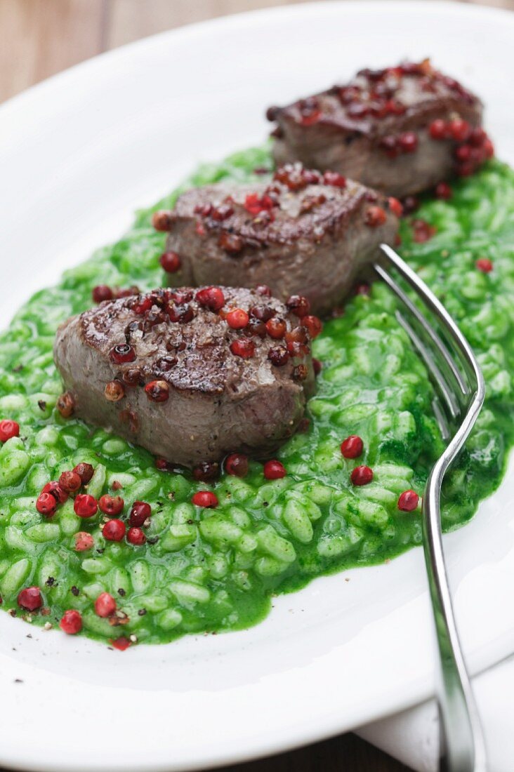 Parsley risotto with venison fillets and pink peppercorns