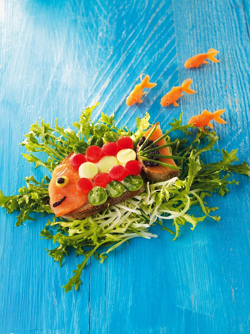 A fish made from bread, salmon and vegetables