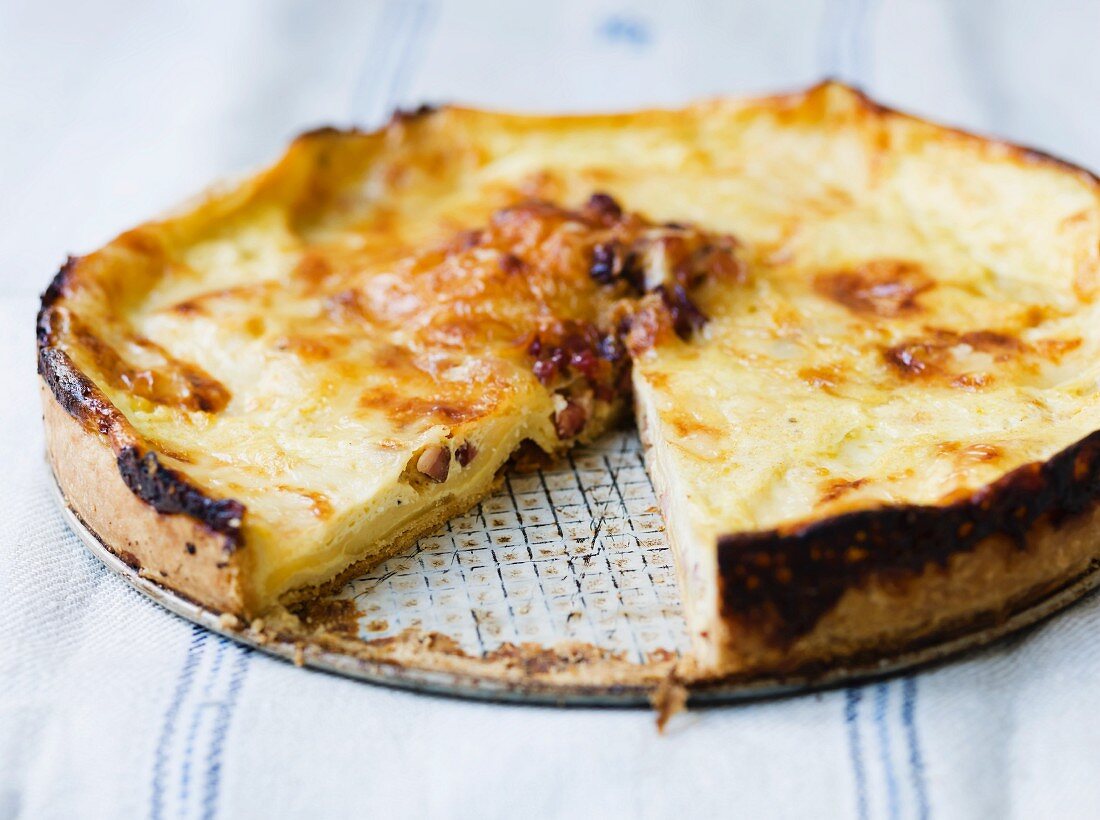 Cheese quiche, partly sliced