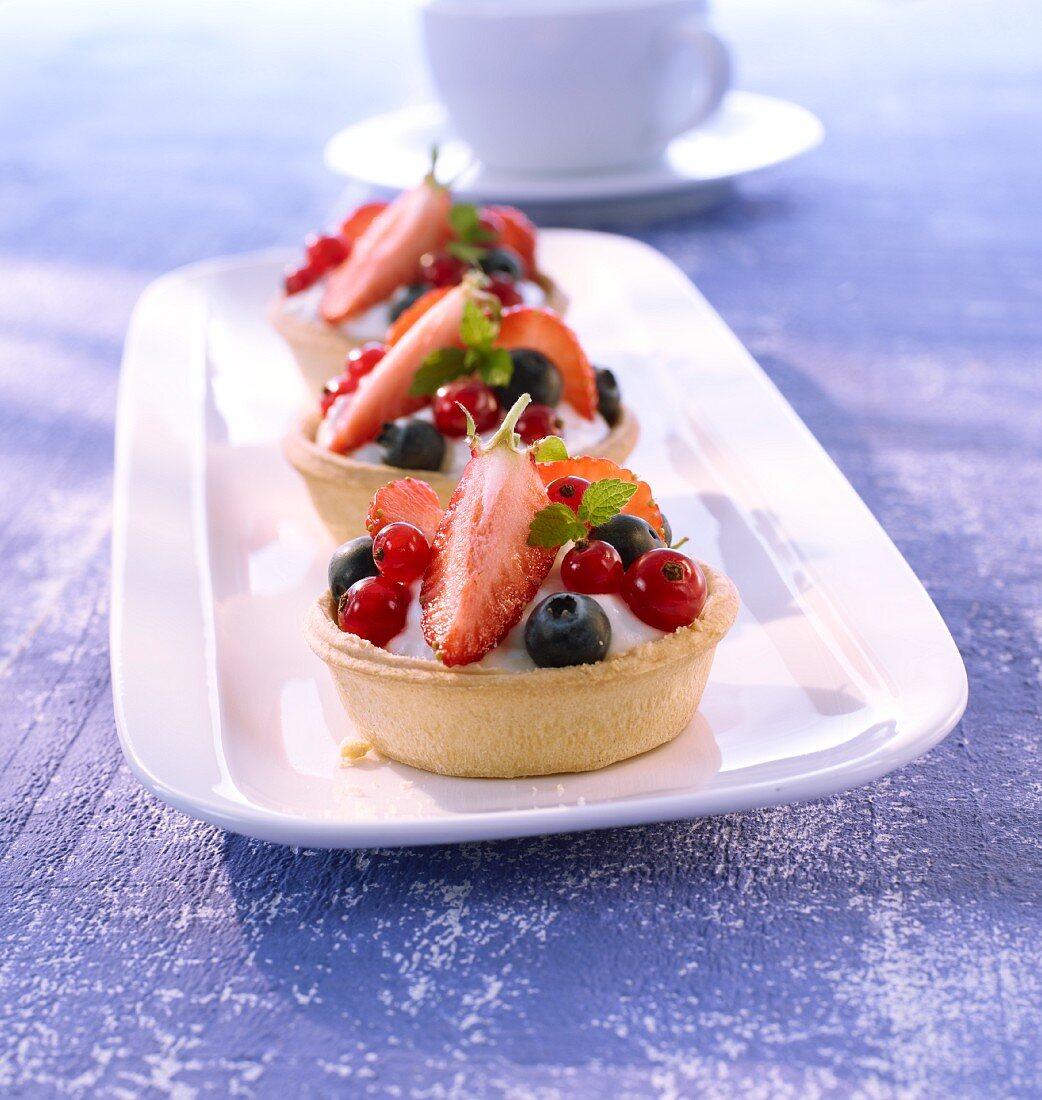 Creamy quark dessert with berries in pastry cases